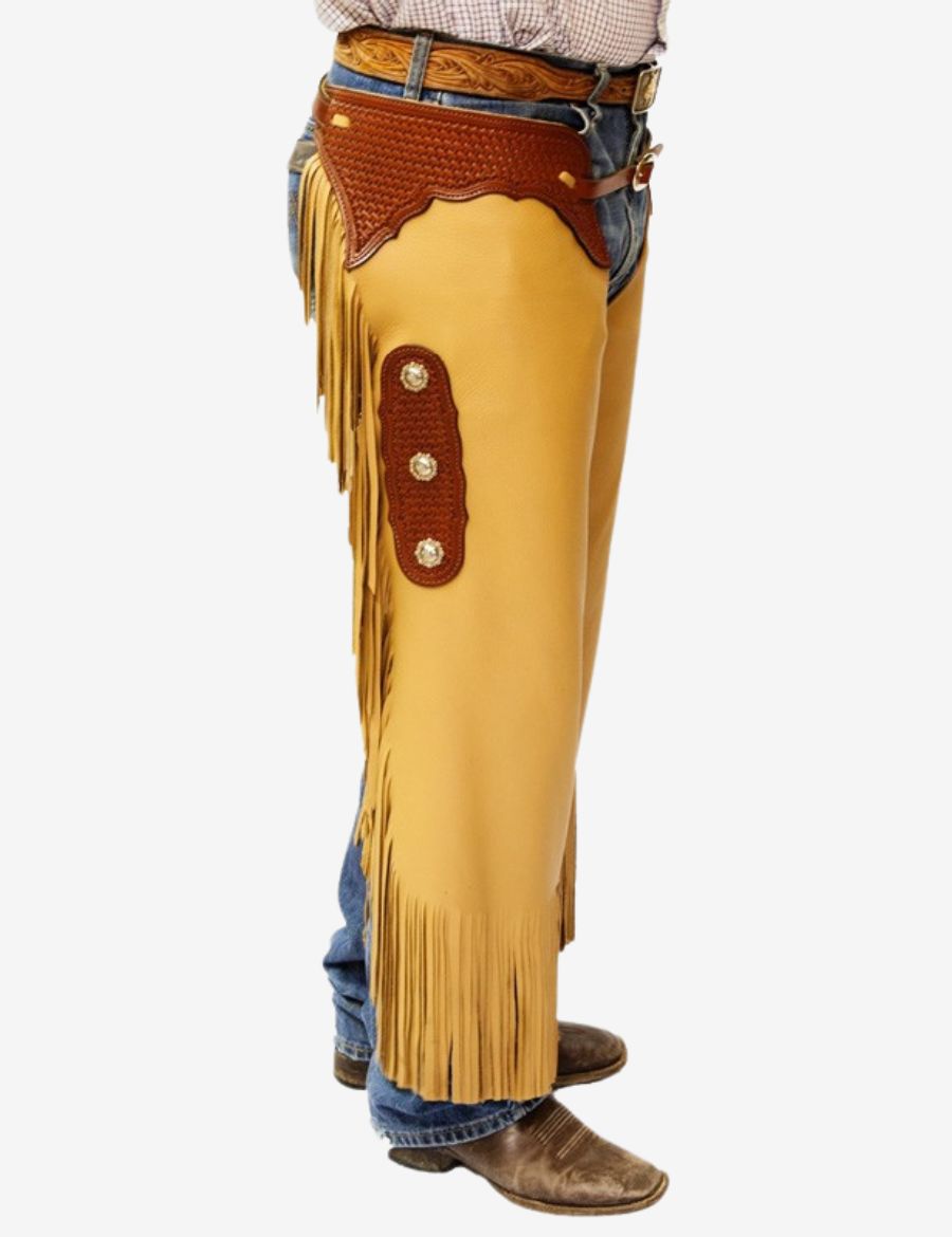 Side model view of western tooled leather chinks chaps with long fringe, concho accents, and cowboy styling.