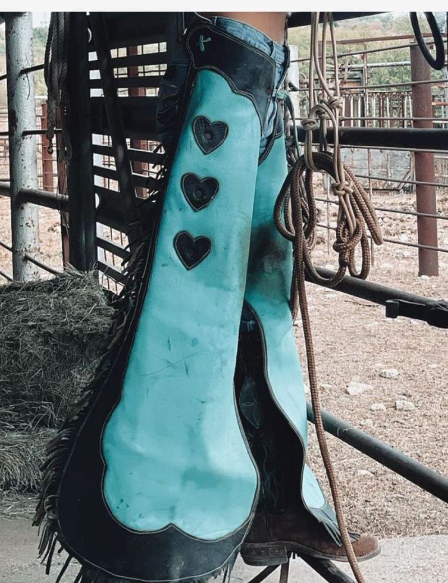 turquoise cowgirl chaps with black scallop leather panels and heart accent detailing.