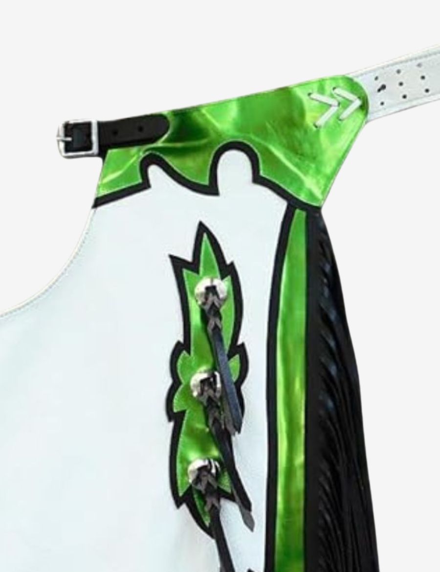 Close-up detail of white rodeo chaps featuring metallic green trim, black accents, and braided concho design.