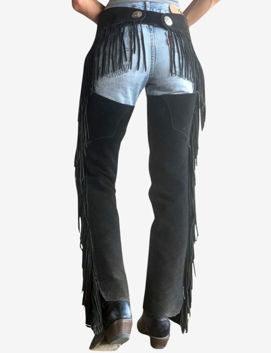 Back view of women black western chaps featuring rear fringe accents and western leather craftsmanship.