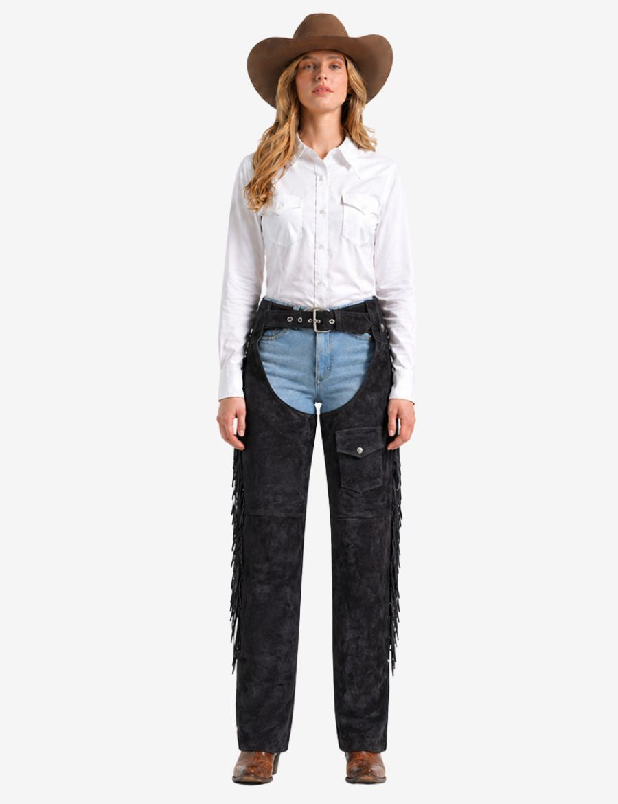 Female model wearing women western fringe chaps with pocket paired with western shirt and cowboy hat.