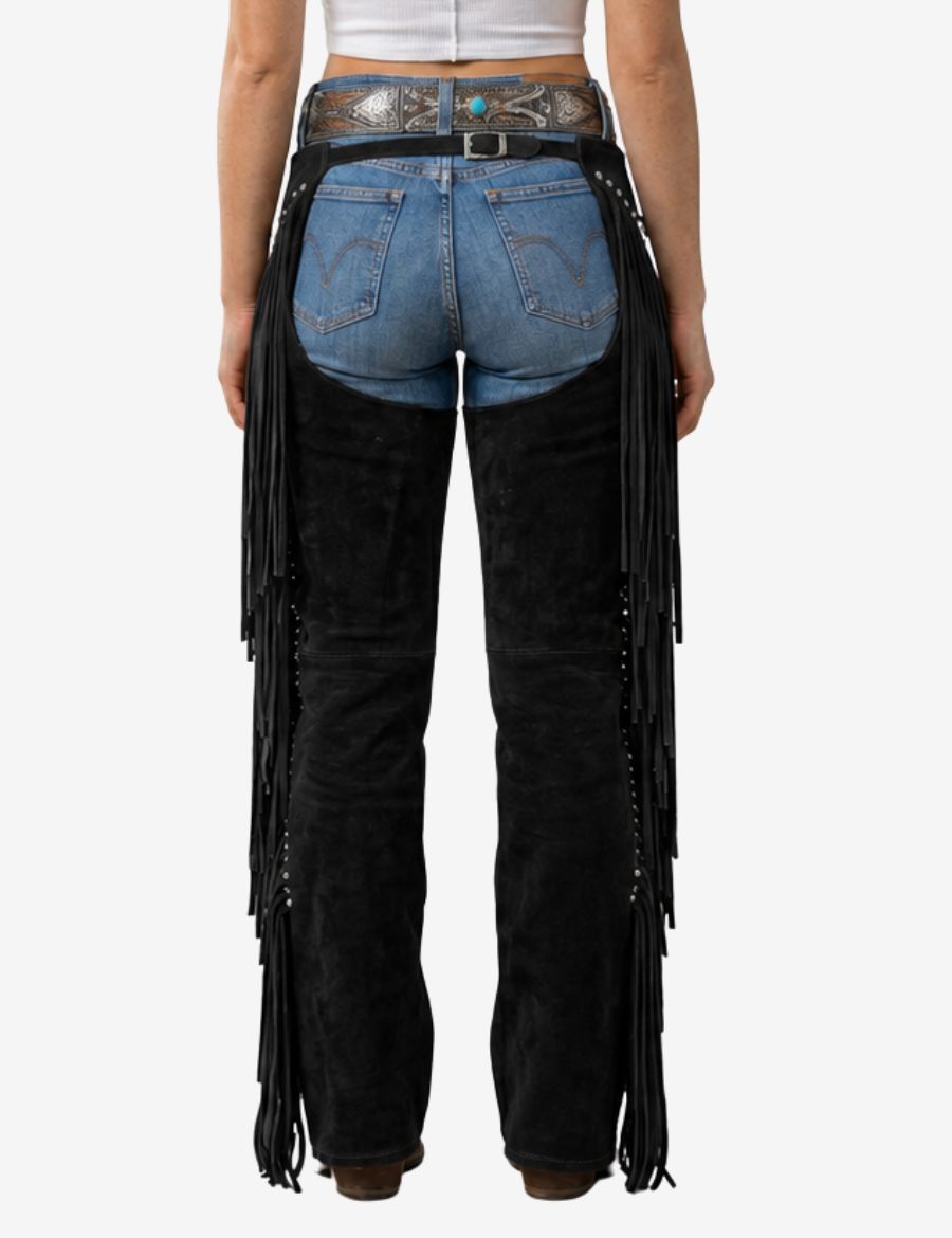 Back view of womens black western chaps with long leather fringe and adjustable western belt styling.