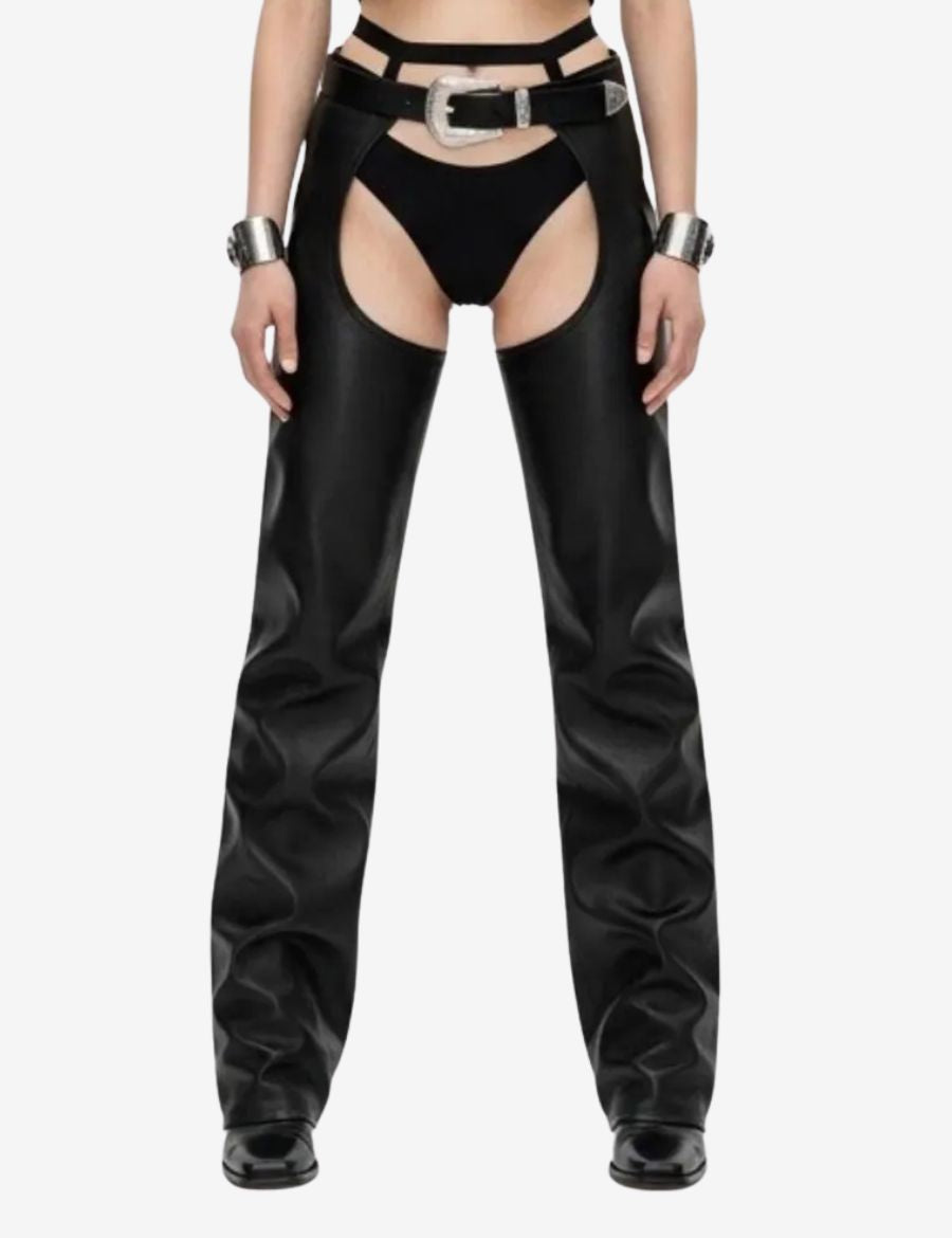 Front view of womens buckled leather buttless chaps crafted from black leather, featuring a statement buckle waist, open-thigh design, and sleek western-inspired styling.