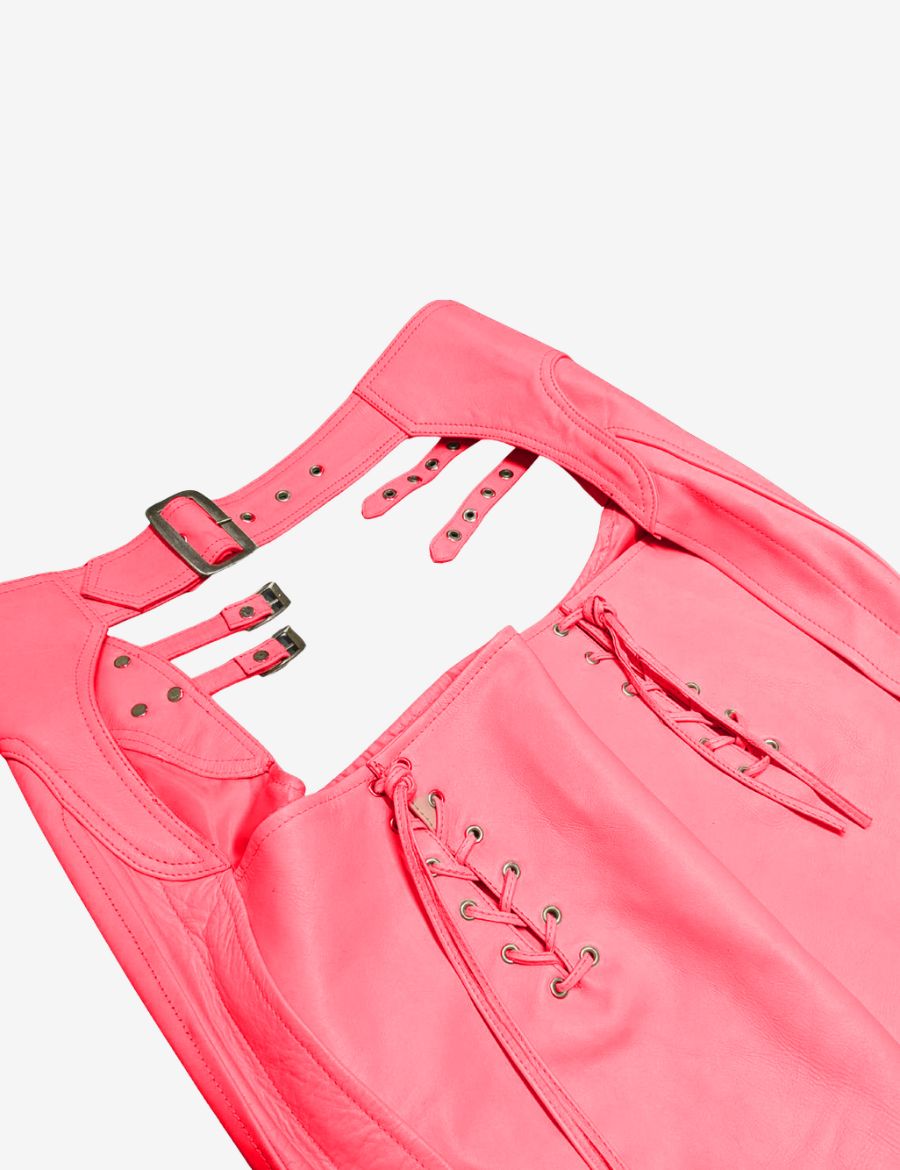 Close-up of womens buckled pink assless chaps highlighting lace-up accents, premium leather texture, reinforced stitching, and adjustable hardware details.