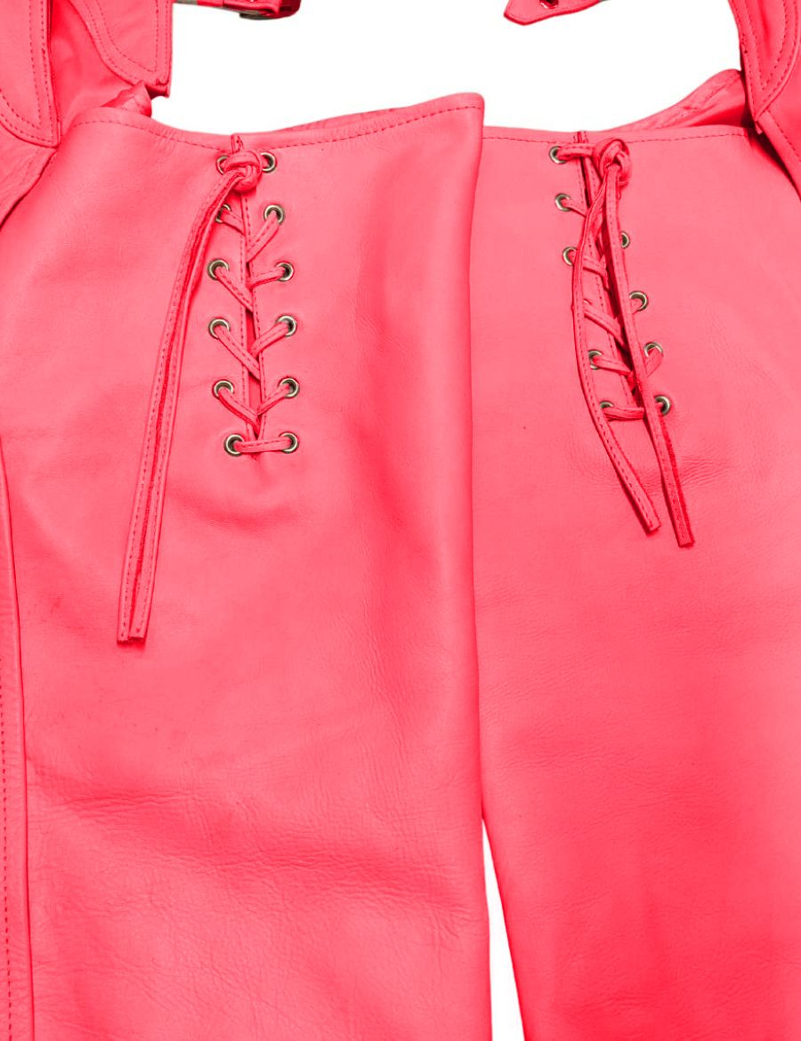 Close-up of womens buckled pink assless chaps featuring rear lace-up detailing, bright pink leather construction, metal eyelets, and handcrafted biker-inspired styling.