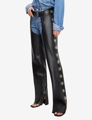Side detail of womens floral concho assless chaps showcasing ornate floral concho accents, smooth black leather construction, front zipper opening, and stylish western craftsmanship.