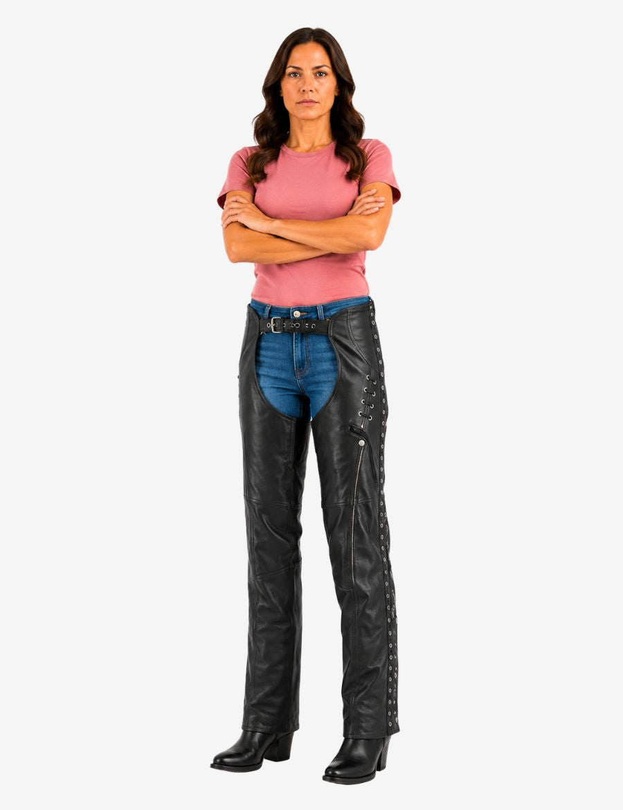 Female model wearing Women's Freedom Eyelet Trim leather chaps with side lace accents and adjustable waist belt.