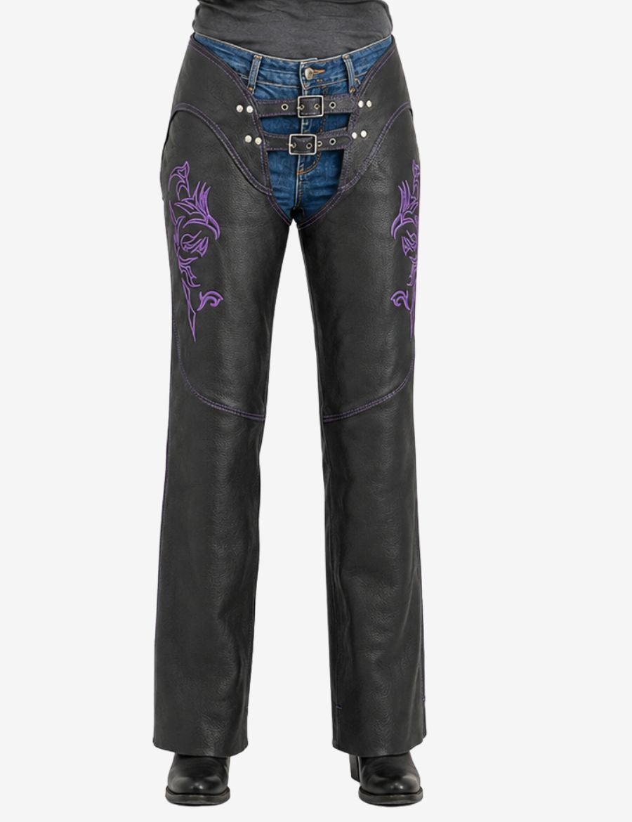 Women's purple embroidered biker chaps in black leather featuring tribal embroidery and dual buckle front closure.