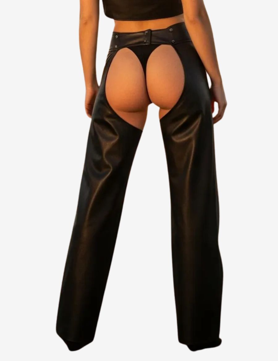 Back view of womens ring buckle assless chaps showcasing smooth black leather, open-back design, western-inspired styling, wide-leg fit, and statement buckle waistband details.